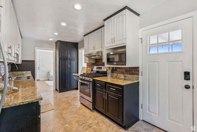2353 E Logan Cir, Salt Lake City, UT 84108 - kitchen with appliances with stainless steel finishes, under cabinet range hood, light stone countertops, tasteful backsplash, and recessed lighting