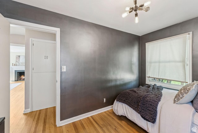 2353 E Logan Cir, Salt Lake City, UT 84108 - bedroom with wood finished floors and a warm lit fireplace
