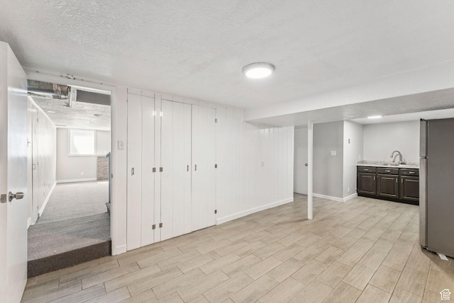 2353 E Logan Cir, Salt Lake City, UT 84108 - below grade area featuring freestanding refrigerator, a textured ceiling, and light wood finished floors