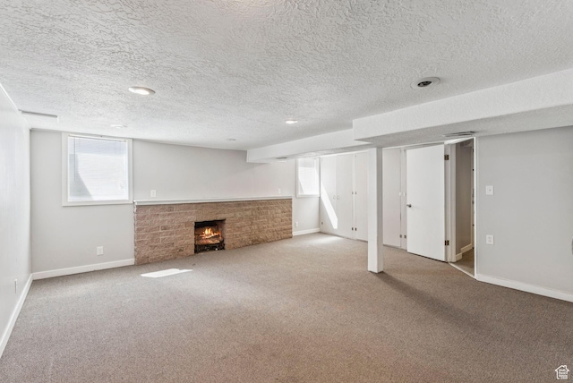 2353 E Logan Cir, Salt Lake City, UT 84108 - below grade area with a fireplace, carpet, a textured ceiling, and healthy amount of natural light