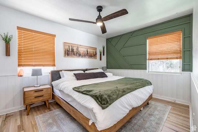 2605 E Simpson Ave, Salt Lake City, UT 84109 - bedroom with wood finished floors, a wainscoted wall, and ceiling fan