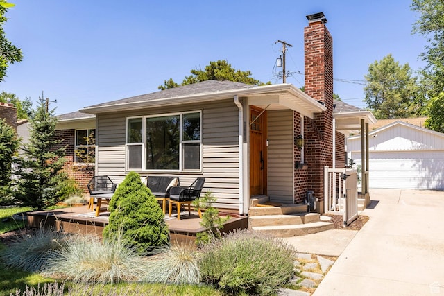 2605 E Simpson Ave, Salt Lake City, UT 84109 - view of front of house featuring an outbuilding, a deck, a chimney, a detached garage, and roof with shingles