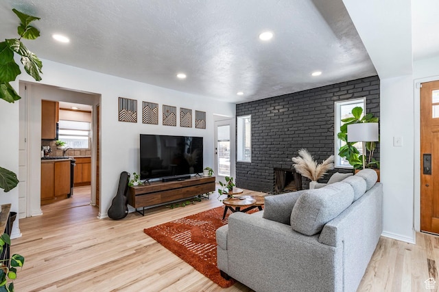 2605 E Simpson Ave, Salt Lake City, UT 84109 - living room with light wood-style floors, recessed lighting, and a fireplace
