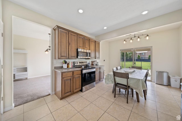 202 S 2035 W, Lehi, UT 84043 - kitchen featuring stainless steel appliances, brown cabinetry, recessed lighting, light tile patterned floors, and light colored carpet