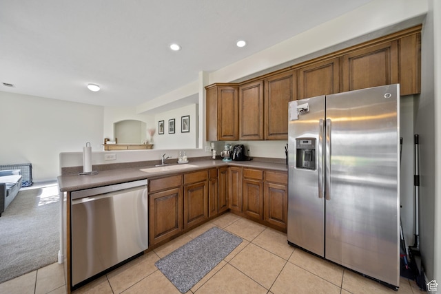 202 S 2035 W, Lehi, UT 84043 - kitchen featuring stainless steel appliances, brown cabinetry, a peninsula, light tile patterned floors, and recessed lighting