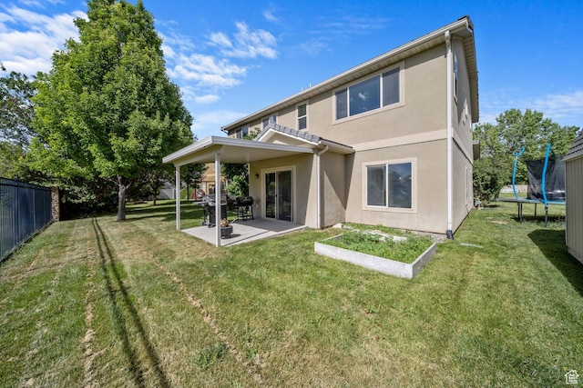 202 S 2035 W, Lehi, UT 84043 - rear view of house with a trampoline, a patio, and stucco siding