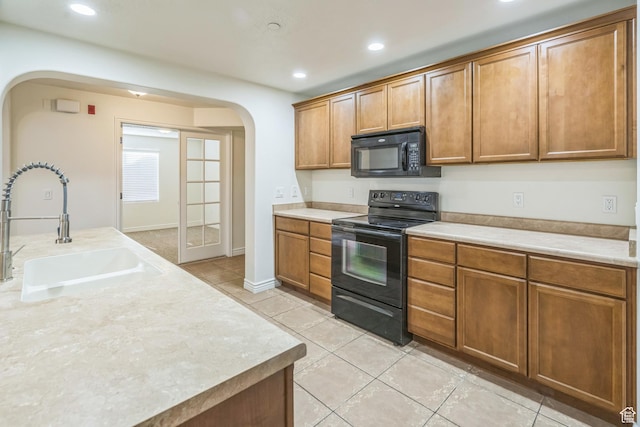 1195 W Dallin Dr Unit R-201, Pleasant Grove, UT 84062 - kitchen featuring black appliances, arched walkways, light tile patterned flooring, light countertops, and recessed lighting