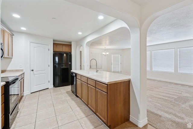 1195 W Dallin Dr Unit R-201, Pleasant Grove, UT 84062 - kitchen with black appliances, arched walkways, light countertops, brown cabinets, and a chandelier