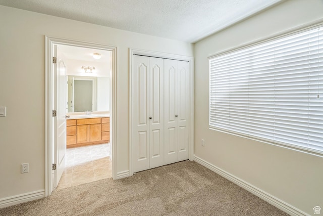 1195 W Dallin Dr Unit R-201, Pleasant Grove, UT 84062 - unfurnished bedroom with light colored carpet, a closet, and a textured ceiling