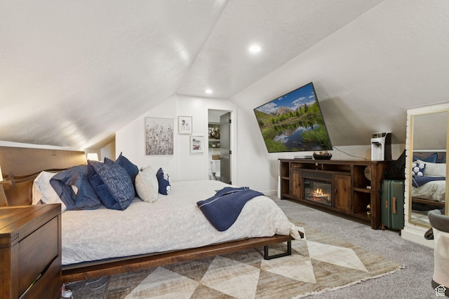 175 Grove Creek Dr N, Pleasant Grove, UT 84062 - bedroom featuring vaulted ceiling, carpet floors, and a glass covered fireplace
