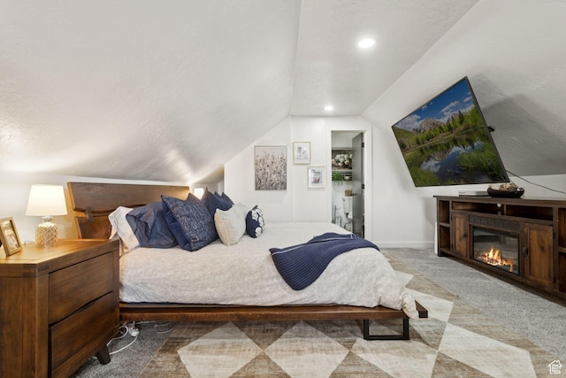 175 Grove Creek Dr N, Pleasant Grove, UT 84062 - bedroom with vaulted ceiling, carpet flooring, a glass covered fireplace, and recessed lighting