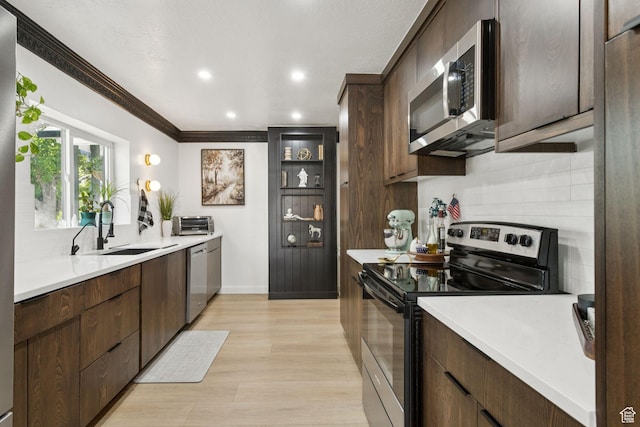 175 Grove Creek Dr N, Pleasant Grove, UT 84062 - kitchen with appliances with stainless steel finishes, backsplash, light countertops, recessed lighting, and dark brown cabinetry