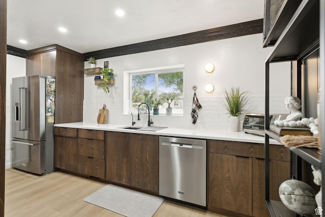 175 Grove Creek Dr N, Pleasant Grove, UT 84062 - kitchen with stainless steel appliances, tasteful backsplash, light wood-style floors, crown molding, and light countertops