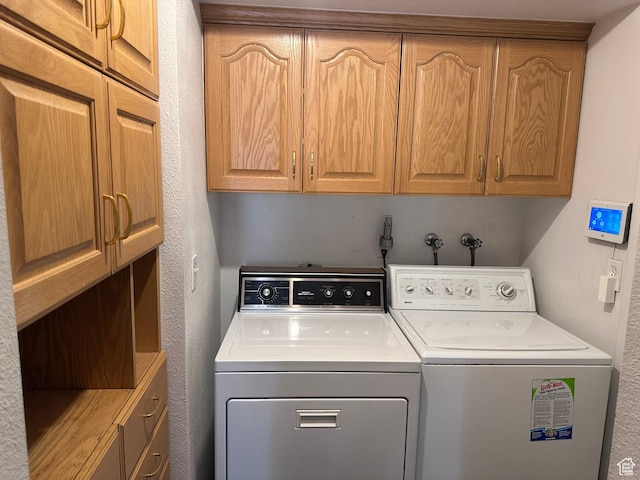 1780 W Homestead Farms Ln S Unit 2, West Valley City, UT 84119 - washroom featuring washer and dryer, cabinet space, and a textured wall
