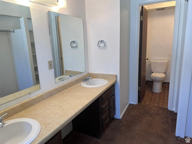 1780 W Homestead Farms Ln S Unit 2, West Valley City, UT 84119 - bathroom featuring double vanity and a closet