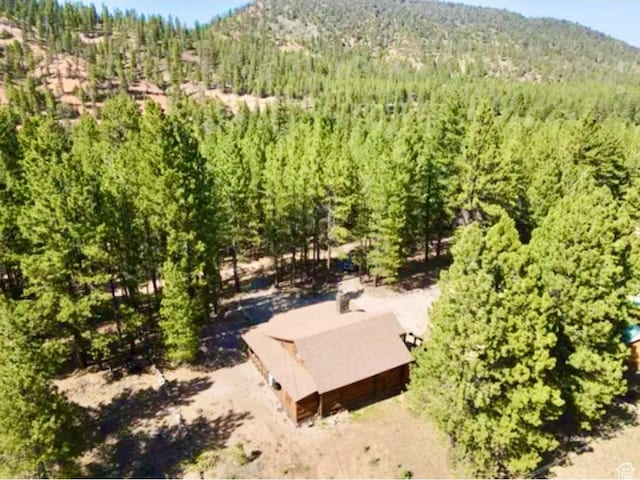 260 E Jensen Trl, Hatch, UT 84735 - aerial view of property and surrounding area featuring a heavily wooded area and a mountainous background