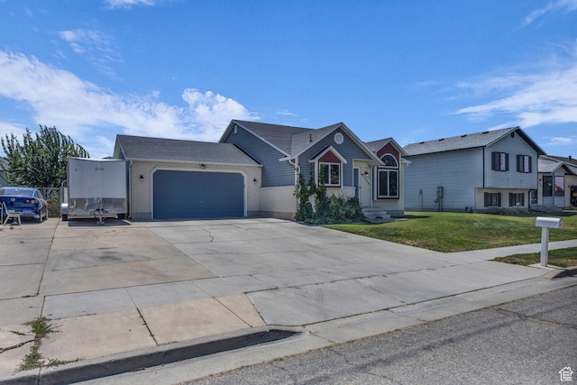 3820 Foxglen Dr, Roy, UT 84067 - view of front of home featuring an attached garage, a front lawn, and concrete driveway