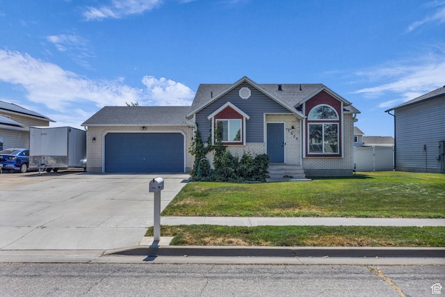 3820 Foxglen Dr, Roy, UT 84067 - view of front of house featuring a garage, brick siding, driveway, a front yard, and roof with shingles