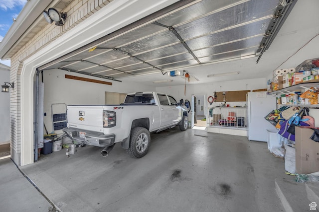 3820 Foxglen Dr, Roy, UT 84067 - garage with freestanding refrigerator and a garage door opener