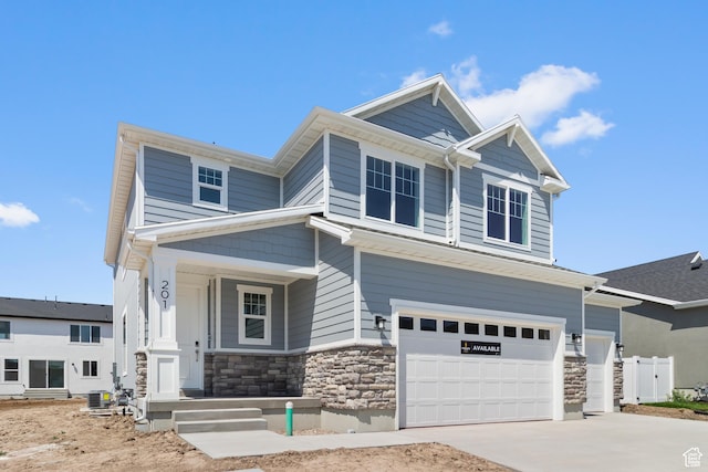 201 E 580 N, Providence, UT 84332 - craftsman house featuring stone siding, concrete driveway, a porch, and an attached garage