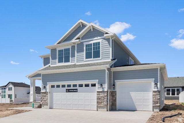 201 E 580 N, Providence, UT 84332 - craftsman-style house with driveway, stone siding, an attached garage, and roof with shingles