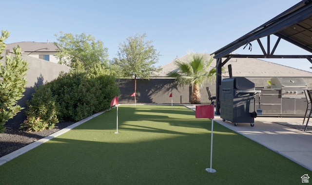 2918 E Willow Tree Ln, St George, UT 84790 - fenced backyard with an area to practice putting