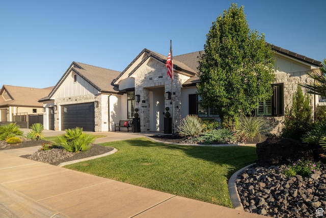 2918 E Willow Tree Ln, St George, UT 84790 - view of front facade featuring stone siding, a garage, a front yard, and driveway