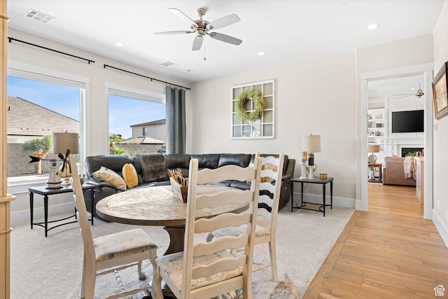 2918 E Willow Tree Ln, St George, UT 84790 - dining area with a ceiling fan, light wood-style flooring, recessed lighting, and a fireplace