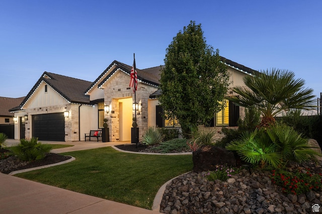 2918 E Willow Tree Ln, St George, UT 84790 - view of front of house with stone siding, an attached garage, a front lawn, and driveway