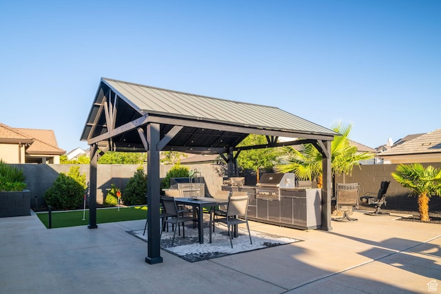 2918 E Willow Tree Ln, St George, UT 84790 - fenced backyard with a gazebo, an outdoor kitchen, outdoor dining area, and a patio