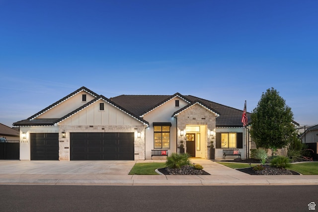 2918 E Willow Tree Ln, St George, UT 84790 - modern inspired farmhouse featuring a garage, driveway, stone siding, and board and batten siding