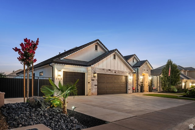 2918 E Willow Tree Ln, St George, UT 84790 - view of front of house with a garage, board and batten siding, concrete driveway, and stone siding