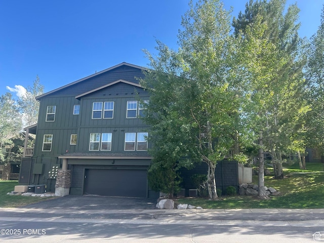 1729 Fox Bay Dr Unit J201, Heber City, UT 84032 - view of front of house featuring board and batten siding, driveway, and an attached garage