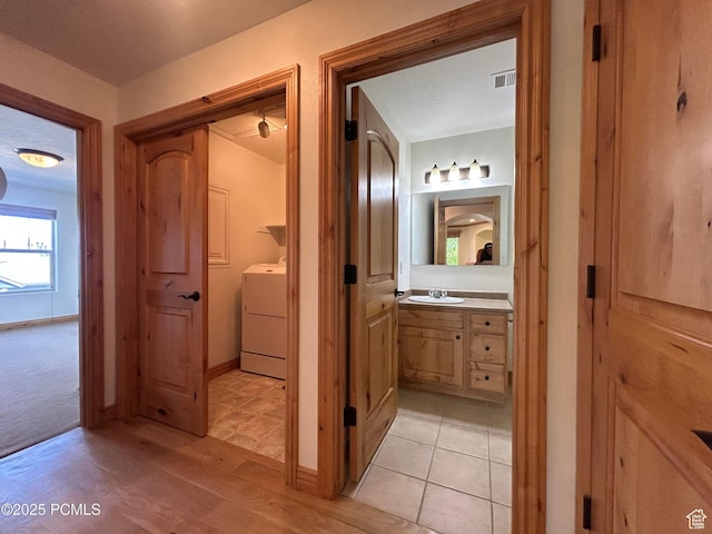 1729 Fox Bay Dr Unit J201, Heber City, UT 84032 - bathroom featuring washer / dryer, vanity, and wood finished floors