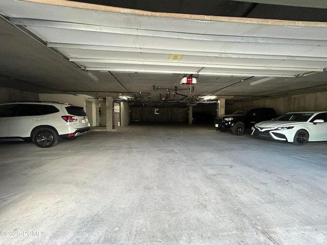1729 Fox Bay Dr Unit J201, Heber City, UT 84032 - parking deck featuring a garage door opener