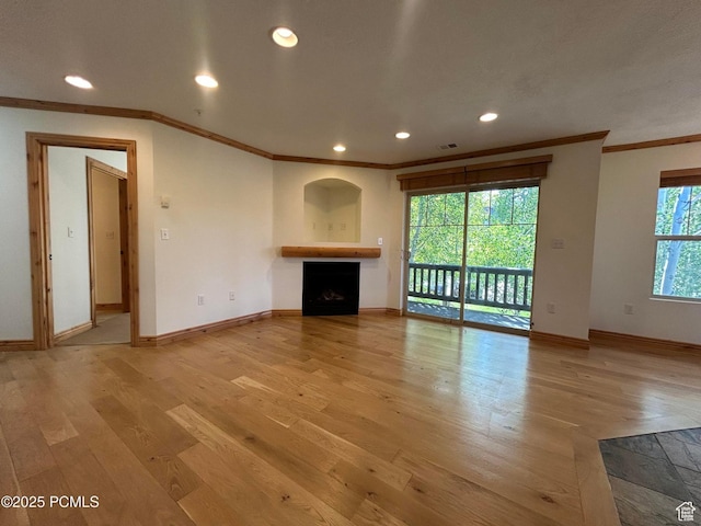 1729 Fox Bay Dr Unit J201, Heber City, UT 84032 - unfurnished living room featuring a fireplace, crown molding, light wood-style floors, and recessed lighting