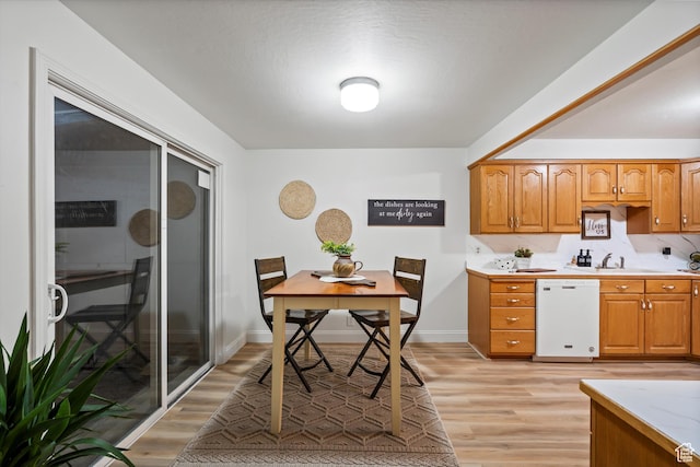 5430 S 850 E, South Ogden, UT 84405 - kitchen with white dishwasher, light wood-type flooring, light countertops, and brown cabinetry