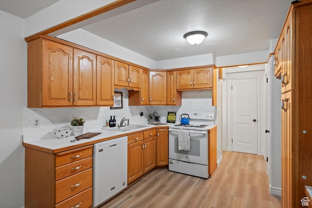 5430 S 850 E, South Ogden, UT 84405 - kitchen with white appliances, light wood-style flooring, tasteful backsplash, light countertops, and brown cabinets