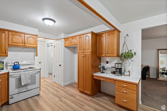 5430 S 850 E, South Ogden, UT 84405 - kitchen featuring electric range, light countertops, built in study area, and brown cabinets