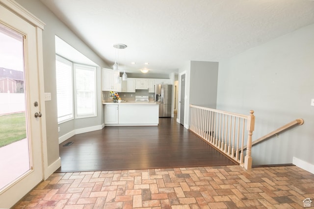 373 S 3240 W, Vernal, UT 84078 - unfurnished living room featuring brick patterned floors and baseboards