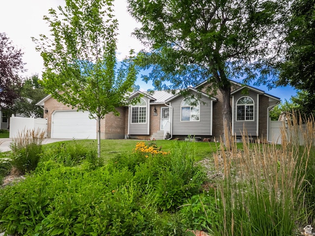 373 S 3240 W, Vernal, UT 84078 - view of front of house featuring an attached garage, concrete driveway, entry steps, and brick siding