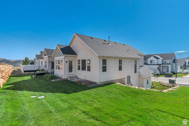 9728 N Aaron Ave Unit 115, Eagle Mountain, UT 84005 - back of property with stucco siding, a yard, entry steps, and a residential view