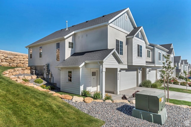 9728 N Aaron Ave Unit 115, Eagle Mountain, UT 84005 - view of property exterior featuring an attached garage, board and batten siding, concrete driveway, a residential view, and a yard