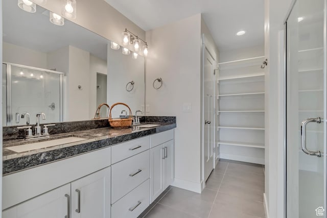 9728 N Aaron Ave Unit 115, Eagle Mountain, UT 84005 - full bath with tile patterned floors, double vanity, a shower stall, and a walk in closet