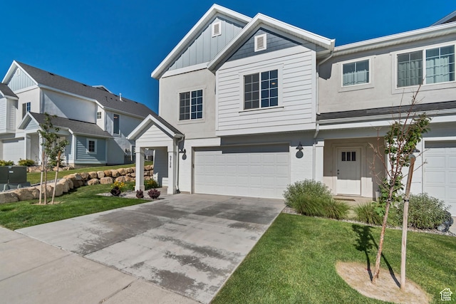 9728 N Aaron Ave Unit 115, Eagle Mountain, UT 84005 - view of front of home with concrete driveway, a garage, board and batten siding, a front yard, and stucco siding