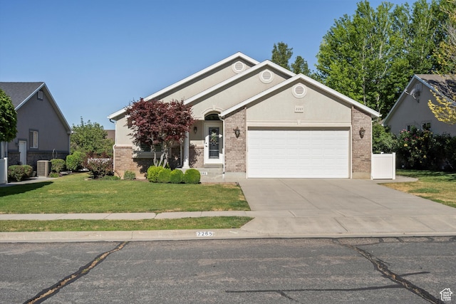 2265 N 515 E, North Ogden, UT 84414 - ranch-style home with driveway, a front yard, a garage, and brick siding