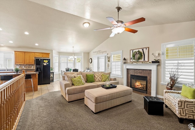 2265 N 515 E, North Ogden, UT 84414 - living room featuring a ceiling fan, a tile fireplace, recessed lighting, vaulted ceiling, and a chandelier