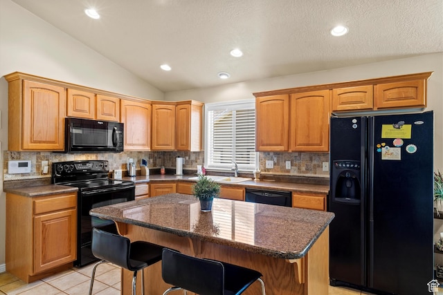 2265 N 515 E, North Ogden, UT 84414 - kitchen with black appliances, a center island, lofted ceiling, tasteful backsplash, and a breakfast bar