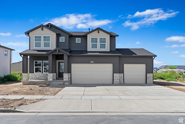 3179 W 3200 S Unit 301, West Haven, UT 84401 - view of front of property featuring stone siding, a garage, and concrete driveway