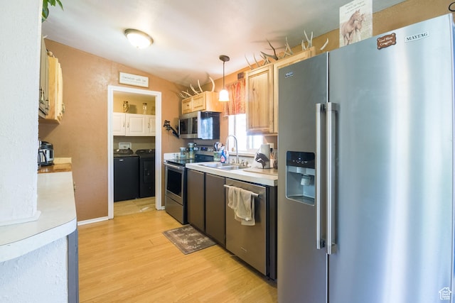 3165 E 5300 S, Vernal, UT 84078 - kitchen featuring appliances with stainless steel finishes, washer and dryer, light wood-style flooring, and light countertops